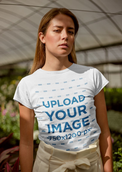 T-Shirt Mockup Featuring a Woman in a Greenhouse
