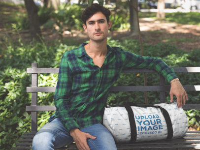 Duffel Mockup Featuring a Man in a Park