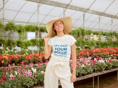 Mockup of a Happy Woman Wearing a Tshirt in a Greenhouse
