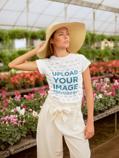 T-Shirt Mockup of a Woman with a Sun Hat in a Greenhouse