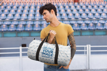 Mockup Featuring a Man Carrying a Duffel Bag in a Stadium