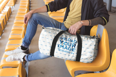 Mockup of a Duffle Bag Featuring a Man Sitting in Stadium Seats
