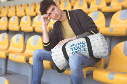 Mockup of a Man Holding a Duffel Bag on a Stadium Seat