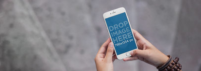 Mockup of a Woman Using Her iPhone 7 at a Staircase