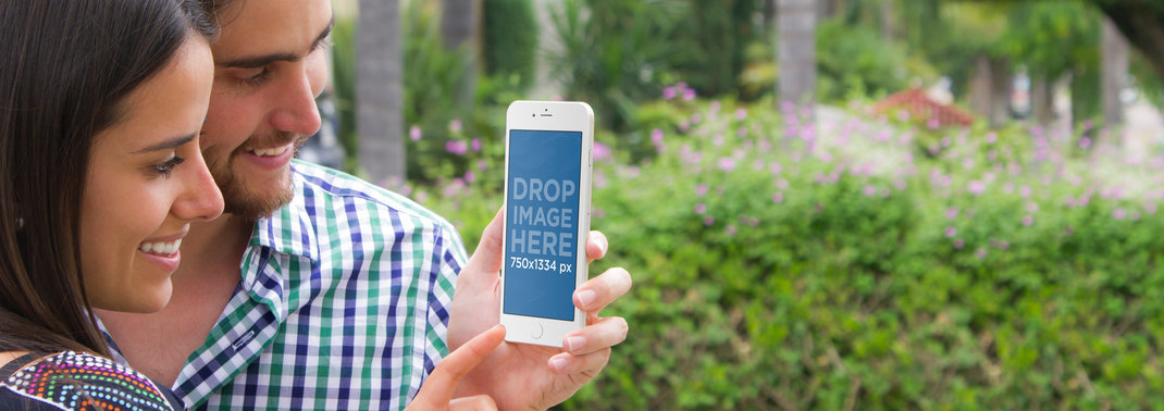 iPhone 6 Mockup of a Young Couple at the Park