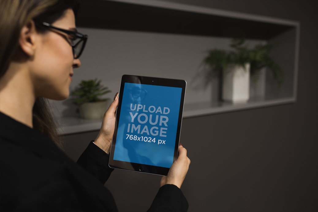 iPad Mockup of a Woman with Glasses Standing by Plant Pots