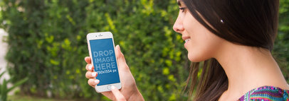 iPhone Mockup Template of a Beautiful Woman at the Garden