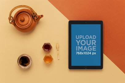 Mockup of an iPad Lying on a Table Next to a Tea Set 22809