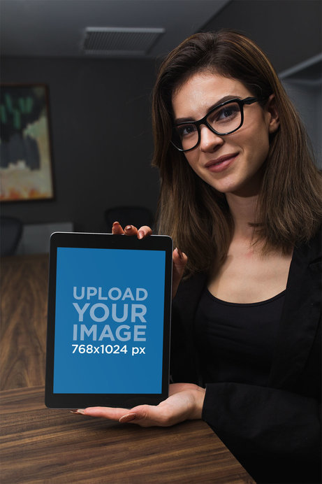 iPad Mockup of a Woman at an Office Meeting Table