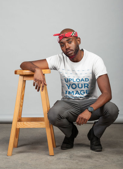 Round Neck Tee Mockup of a Stylish Man in a Crouching Pose