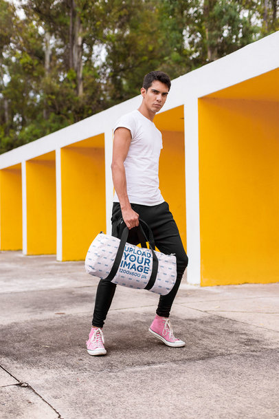 Mockup of a Serious Man Carrying a Gym Bag Outdoors