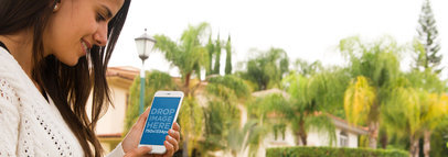 Mockup of a Young Woman Using an iPhone 6 Outside her House a4426