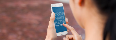 iPhone 6 Mockup Featuring a Woman Using an iPhone at the Park
