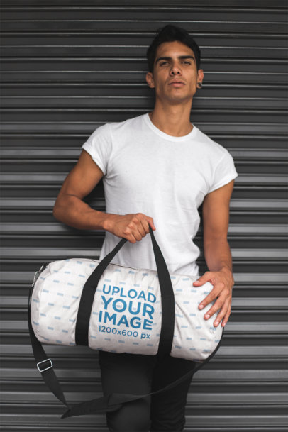 Duffle Bag Mockup of a Man Leaning Against a Closed Store Curtain