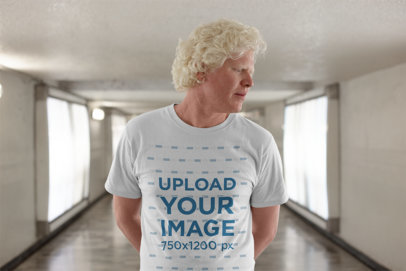 T Shirt Mockup of a Serious Man with Curly Hair in a Hallway