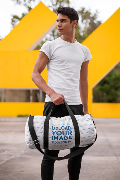 Mockup of a Serious Man Holding a Gym Bag Outdoors
