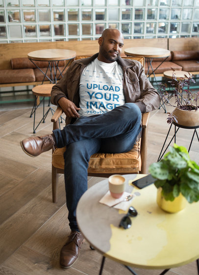 T-Shirt Mockup Featuring a Man in a Cool Café