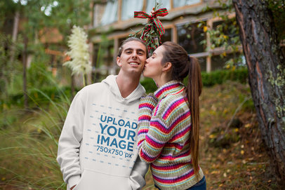 Christmas Sweatshirt Mockup of a Man Being Kissed by His Girlfriend Under Mistletoe