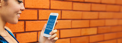 iPhone 6 Mockup Template of a Young Lady Against a Brick Wall