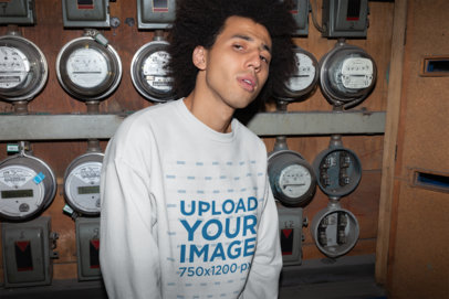 Crewneck Sweater Mockup Featuring a Man Standing Against Electricity Meters 22302