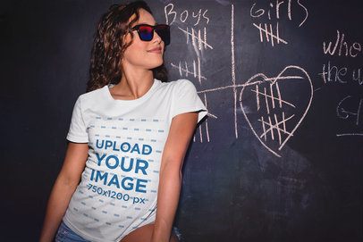 T-Shirt Mockup of a Trendy Woman in Front of a Chalkboard 