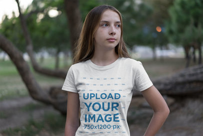 Mockup of a Serious Young Girl Wearing a Tee in a Park