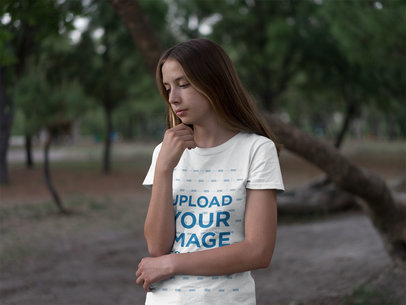 Mockup of a Young Woman Wearing a Tee in the Woods
