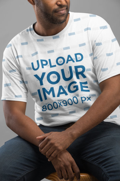 Mockup of a Sublimated Tee Worn by a Man in a Studio