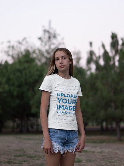 Camping T-Shirt Mockup Featuring a Teen Girl in a Grassland