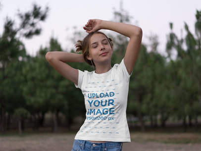 Camping T-Shirt Mockup Featuring a Teen Girl in a Field
