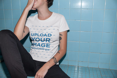 Tshirt Mockup Featuring a Short-Haired Girl Sitting Against a Bathroom Wall 22198