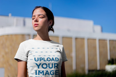 Tee Mockup of a Woman Closing Her Eyes From The Sun