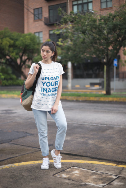 Mockup of a Casual Young Woman Wearing a Unisex Tee in the City