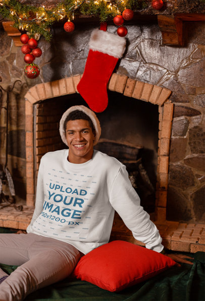 Sweatshirt Mockup Featuring a Man Sitting Under a Christmas Stocking