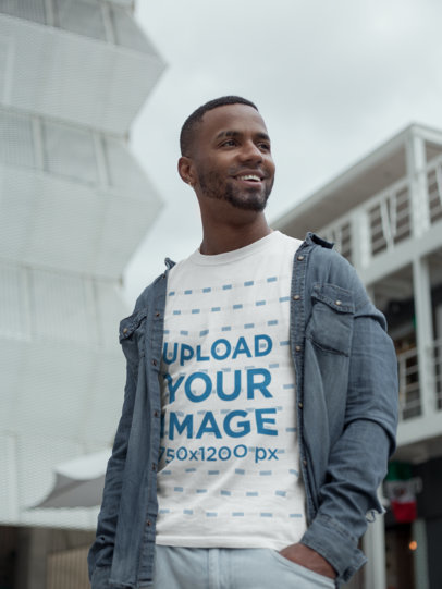T-Shirt Mockup of a Smiling Man Walking in the City