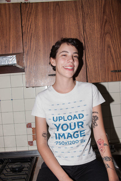 Mockup of a Woman Wearing a T-shirt Sitting on a Kitchen Counter