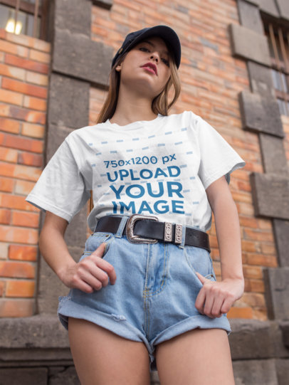 Mockup of a Chic Woman Wearing a Unisex Tee Looking down at the Camera
