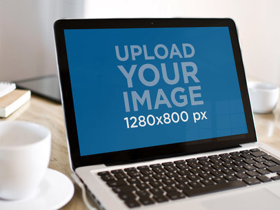 Mockup of Black MacBook at an Office's Desk
