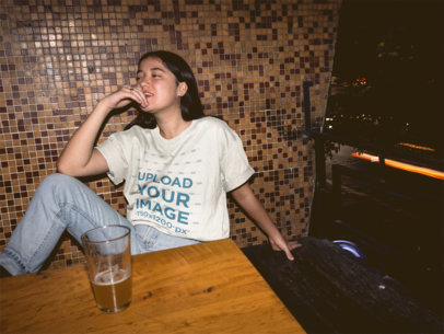 Unisex Tee Mockup Featuring a Cool Woman at a Bar