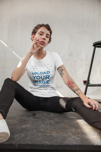 Tee Mockup Featuring an Alternative Young Woman Sitting on the Floor