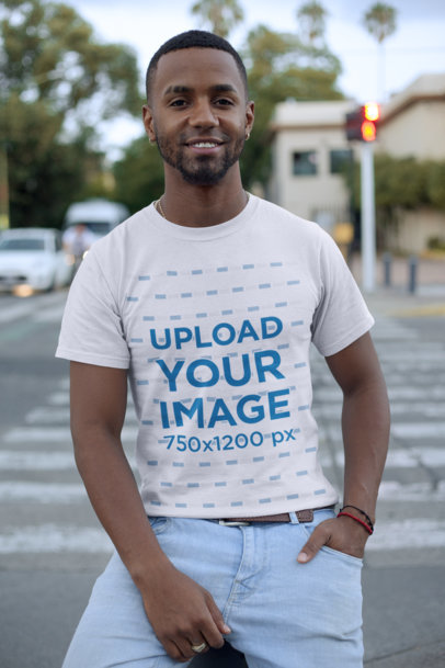 Mockup of a Man Standing On a Street Corner Wearing a Tee