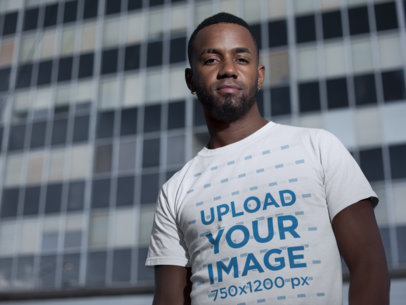 Mockup of a Cool Man Wearing a Tee in Front of a Skyscraper 22772