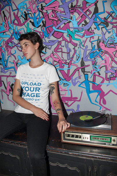 T-Shirt Mockup of an Alternative Woman Listening to a Record Player