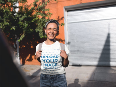 T-Shirt Mockup of a Happy Woman Carrying a Backpack
