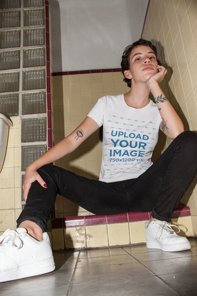 Tee Mockup of a Woman with Short Hair Sitting on a Bathroom Floor 22213