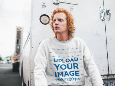 Sweatshirt Mockup Featuring a Serious Man With Red Hair Sitting on a Cargo Trailer