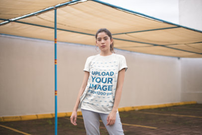 Mockup of a Serious Woman Wearing a Unisex Tee and Hoop Earrings