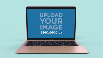 Simple Mockup of a Gold MacBook Air Resting Over a Solid Surface 23681