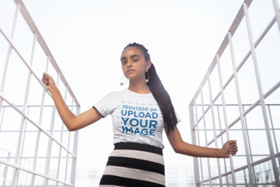 T-Shirt Mockup of a Woman with Braids at an Urban Structure