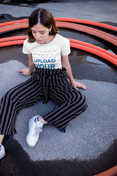 T-Shirt Mockup Featuring a Contemplative Woman Sitting on the Ground 20684